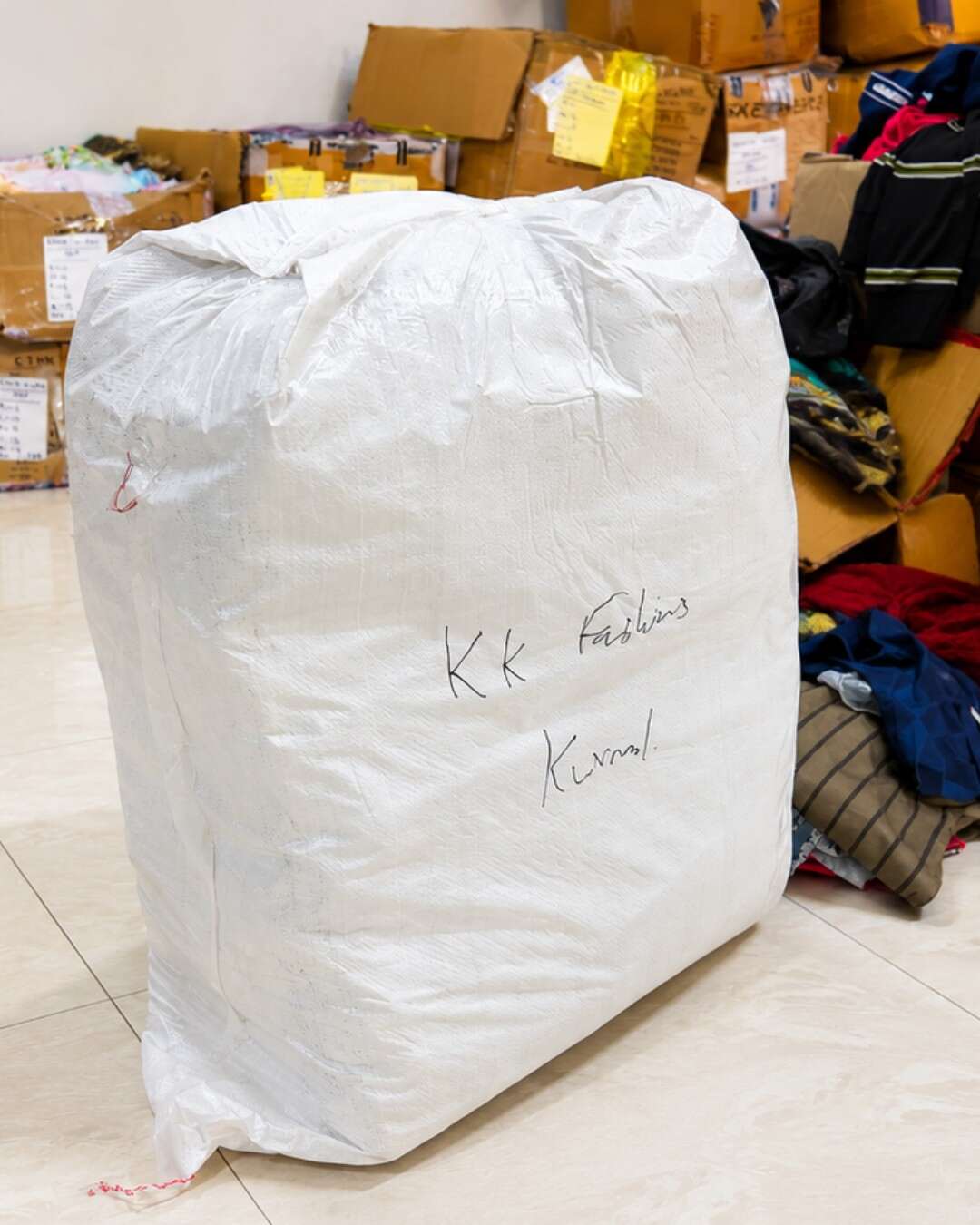Packed stocklot garments and clothing cartons in warehouse